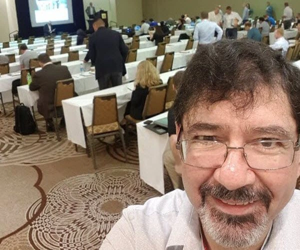 A man taking a picture during a conference