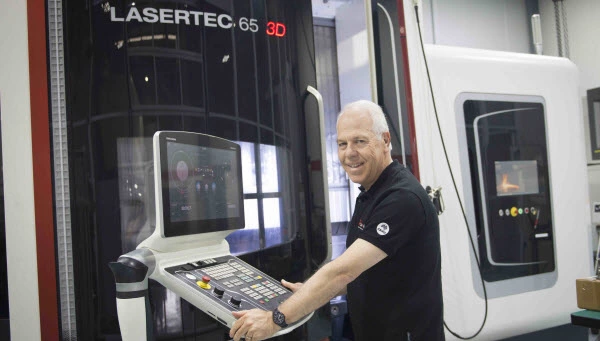 Happy man using a Lasertec 3D machine